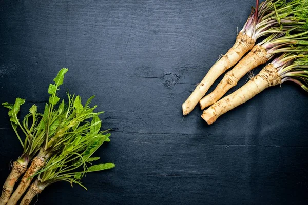 Taze horseradish. Siyah ahşap masanın üzerinde. Üstten Görünüm.