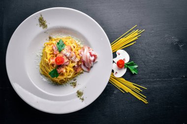 Kremalı sos pastırma ile makarna. Geleneksel İtalyan yemekleri. Ahşap bir arka plan üzerinde. Üstten Görünüm. Metniniz için boş alan.