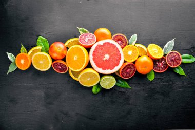 Taze narenciye. Limon portakal, mandalina, limon. Bir siyah arka plan üzerine tahta. Üstten Görünüm.