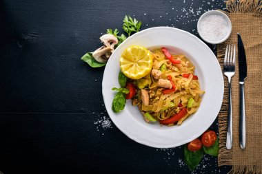 Makarna tavuk fileto, parmesan peyniri ve mantar ve fesleğen. Bir siyah ahşap yüzeye. Metniniz için boş alan. Üstten Görünüm.