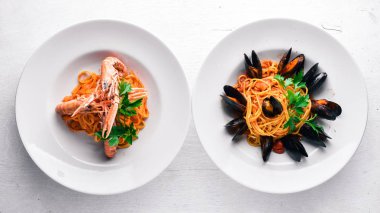 Makarna midye ve deniz ürünleri ile. Geleneksel İtalyan yemekleri. Ahşap bir arka plan üzerinde. Üstten Görünüm. Metniniz için boş alan.