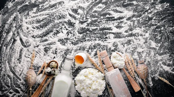 Ekmek, peynir ekşi krema, süt, un, yumurta için hazırlık. Siyah ahşap arka plan üzerinde. Üstten Görünüm. Boş alan.