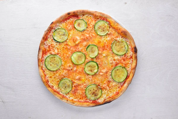 Zucchini Pizza on wooden background.