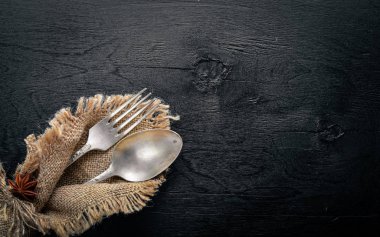 Çatal, kaşık ve çatal ahşap arka plan üzerinde eski kumaş. Üstten Görünüm. Boş alan.