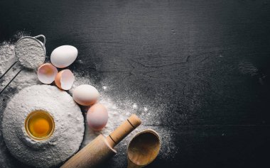 Pişirme için hazırlık. Bir oklava ile yumurta. Taş masanın üstünde. Metin için özgür yer. Üstten Görünüm.