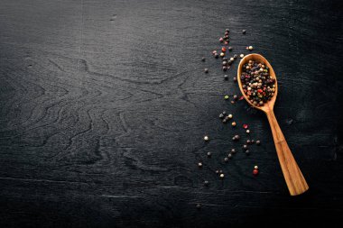 Güzel kokulu baharatlar kümesi. Siyah ve kırmızı biber, kişniş, kırmızı biber karışımı. Ahşap arka plan üzerinde. Üstten Görünüm. Boş alan.