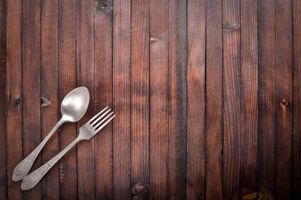 Old cutlery On Wooden background.