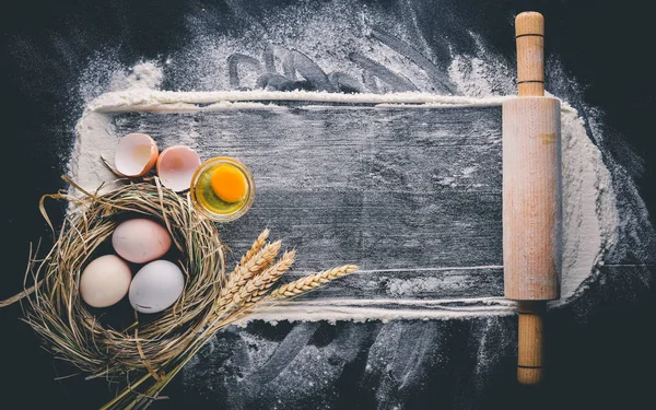 Pişirme için hazırlık. Bir oklava ile yumurta. Taş masanın üstünde. Metin için özgür yer. Üstten Görünüm.