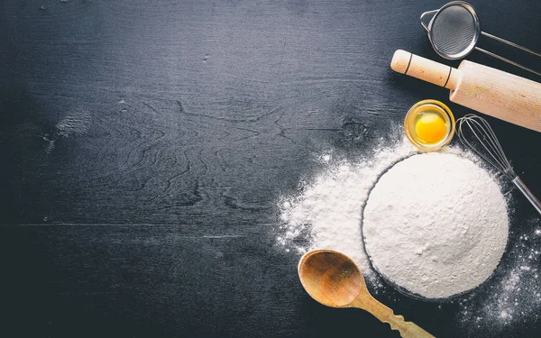 Preparation for baking. Eggs with a rolling pin. On the stone table. Free space for text . Top view. — Stock Photo, Image
