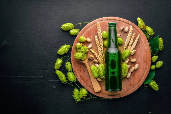 stock image A bottle of beer, hops and grain. Top view. Free space for text.