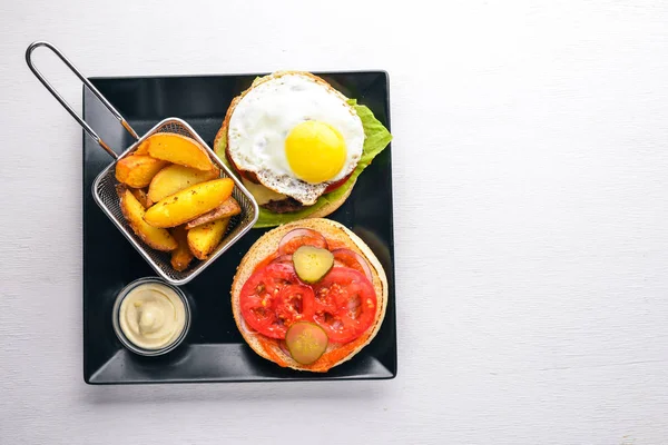 아침 식사입니다. 감자 튀김 및 고기와 계란 버거 에 나무 배경. 최고의 볼 수 있습니다. 여유 공간. — 스톡 사진