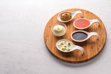 Baharat ve soslar kümesi. Ahşap bir arka plan üzerinde. Üstten Görünüm. Metin için boş alan.