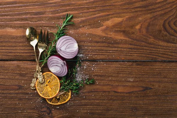 Preparation for cooking. Old cutlery. On a wooden surface. Top view. Free space for your text.