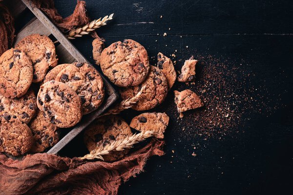 Cookies with chocolate. On a wooden background. Top view. Free space for your text.