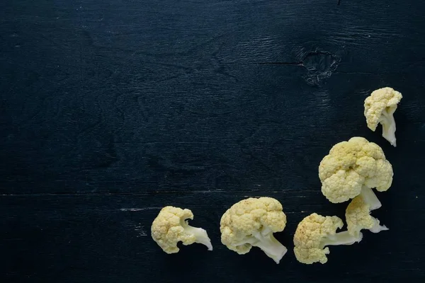 Cauliflower. On a black wooden background. Top view. Free space. — Stock Photo, Image