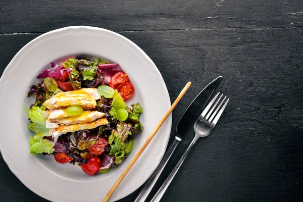 Ahşap arka plan üzerinde tavuk ve mango soslu sebze salatası. Üstten Görünüm. Metin için boş alan.