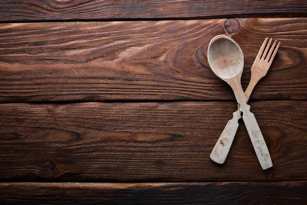 Kitchen wooden appliances on a wooden surface. Top view. Free space for your text. — Stock Photo, Image