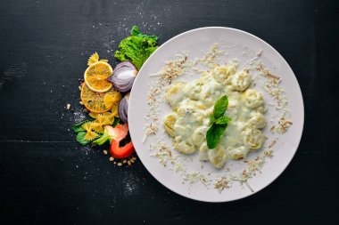 Patates köfte peynir ve krema sosu. Üstten Görünüm. Metin için özgür yer. Ahşap bir arka plan üzerinde.