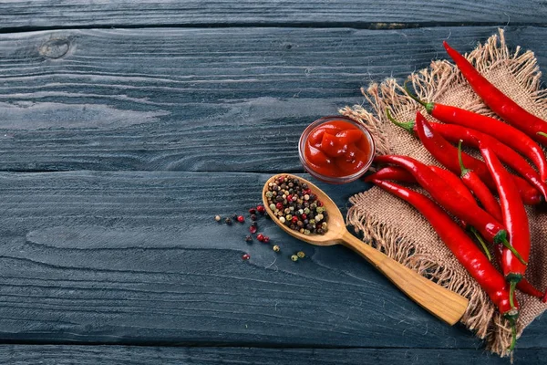 Hot spices Chili and Spice Red Peppers. On a wooden background. Top view. Free space for your text. — Stock Photo, Image