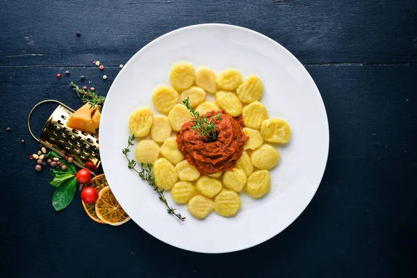 Potato dumplings. Top view. Free space for text. On a wooden background. — Stock Photo, Image