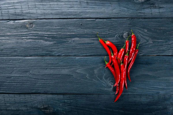 Chili red pepper. On a wooden background. Top view. Free space for your text. — Stock Photo, Image