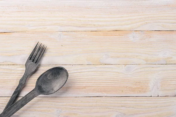 Old cutlery. On a wooden background. Top view. Free space for text.