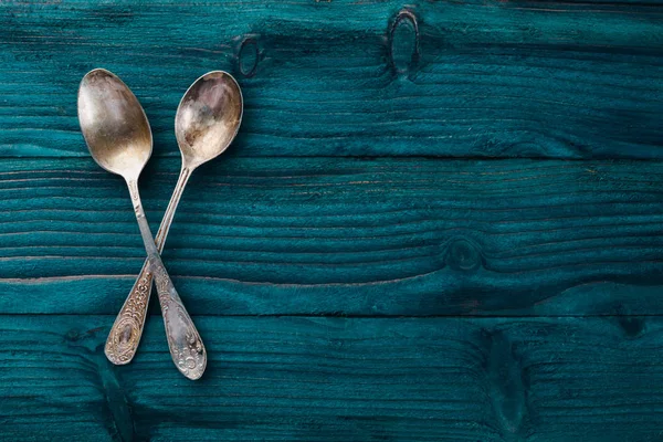 Old cutlery. On a wooden background. Top view. Free space for text.