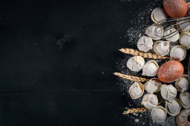 Geleneksel Rus mantı, mantı, mantı siyah beton zemin üzerine etli. Üstten Görünüm. Boşaltmak.