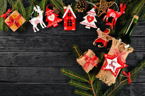 Uma mesa de Natal e uma garrafa de vinho. Ano Novo. Árvore de Natal e decorações de árvores de Natal. Em um fundo de madeira. Espaço livre para texto . — Fotografia de Stock