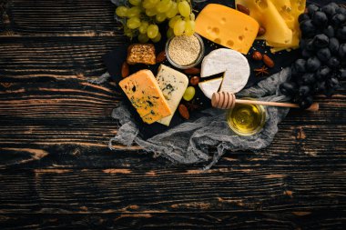 Üzüm, kırmızı şarap, peynir, bal ve fındık ahşap arka plan üzerinde. Üstten Görünüm.