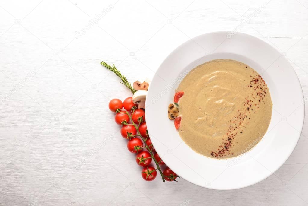 Mushroom puree soup. On a wooden background. Free space for your text. Top view.