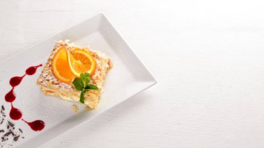 Portakal lezzet ile katmanlı pasta. Ahşap bir arka plan üzerinde. Metniniz için boş alan. Üstten Görünüm.