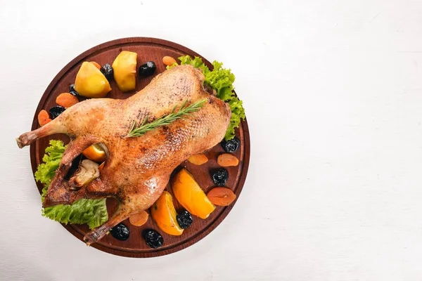 Baked turkey with vegetables and spices. Thanksgiving day. Goose chicken grill. On a wooden background. Top view.