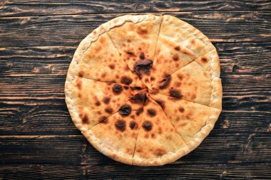 Pizza volkan. Gorgonzola peyniri, domates, taze sebze ve baharat. Ahşap bir arka plan üzerinde. Metniniz için boş alan. Üstten Görünüm.