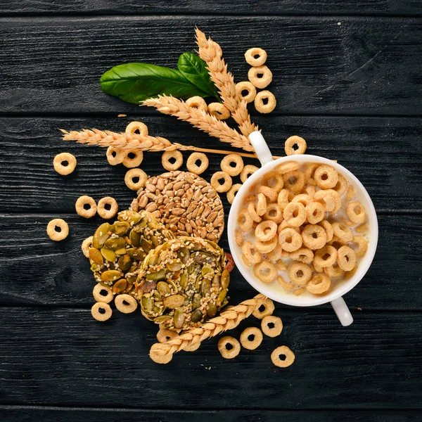 Fitness breakfast, muesli, milk, fruits, nuts and seeds, on a wooden surface. Top view. Free space for text.