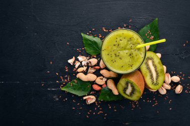 Keten tohumu ve fındık ile kivi güler yüzlü. Ahşap bir arka plan üzerinde. Üstten Görünüm. Metniniz için boş alan.