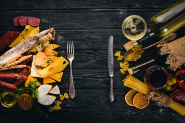 Çeşitli peynir, sosis, şaraplar, geleneksel baharat ve ahşap arka plan üzerinde taze sebze. Peynir brie, mavi peynir, gorgonzola, fuete, salam. İtalyan ve İspanyol mutfağı. Boş alan.