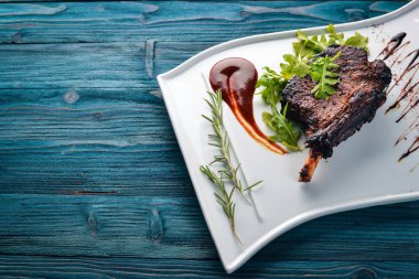 Domates ve bir fındık ile bir kemik biftek. Biftek Fiorentino. Ahşap bir arka plan üzerinde. Metniniz için boş alan. Üstten Görünüm.