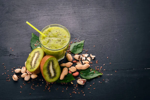 Keten tohumu ve fındık ile kivi güler yüzlü. Ahşap bir arka plan üzerinde. Üstten Görünüm. Metniniz için boş alan.