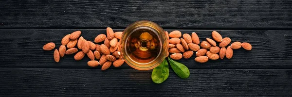 Amaretto Almond Liquor. Almond On a wooden background. Italian drink Top view. Free space for text.