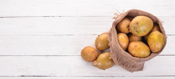 Raw potatoes. On a white background. Cooking. Free space for text. Top view.