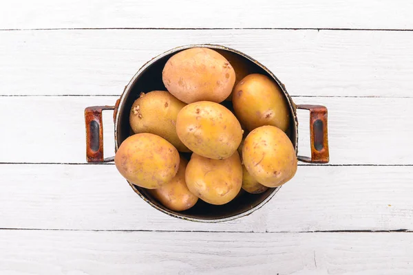 Raw potatoes. On a white background. Cooking. Free space for text. Top view.