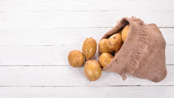 Raw potatoes. On a white background. Cooking. Free space for text. Top view.