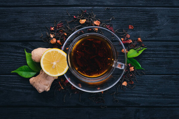 Tea with lemon and ginger. Hot drink On a wooden background. Top view. Copy space.