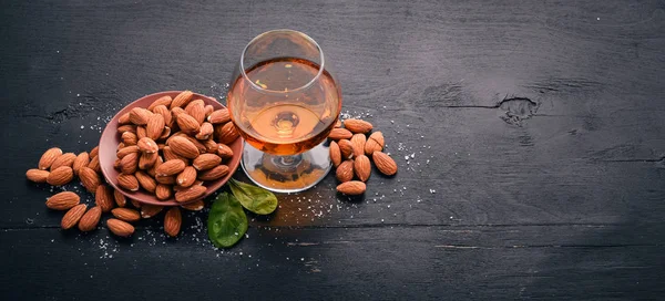 Amaretto Almond Liquor. Almond On a wooden background. Italian drink Top view. Free space for text.
