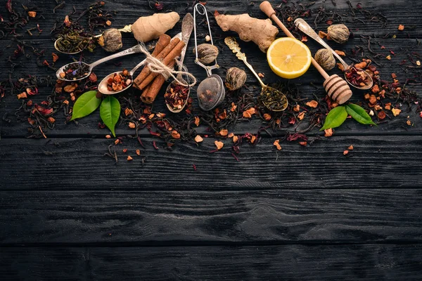 Assortment of dry teas and fragrant herbs and spices. On a wooden background. Top view. Copy space.