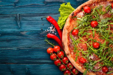Pizza Primavera. Kiraz domates, roka, peynir. Ahşap bir arka plan üzerinde. Üstten Görünüm.