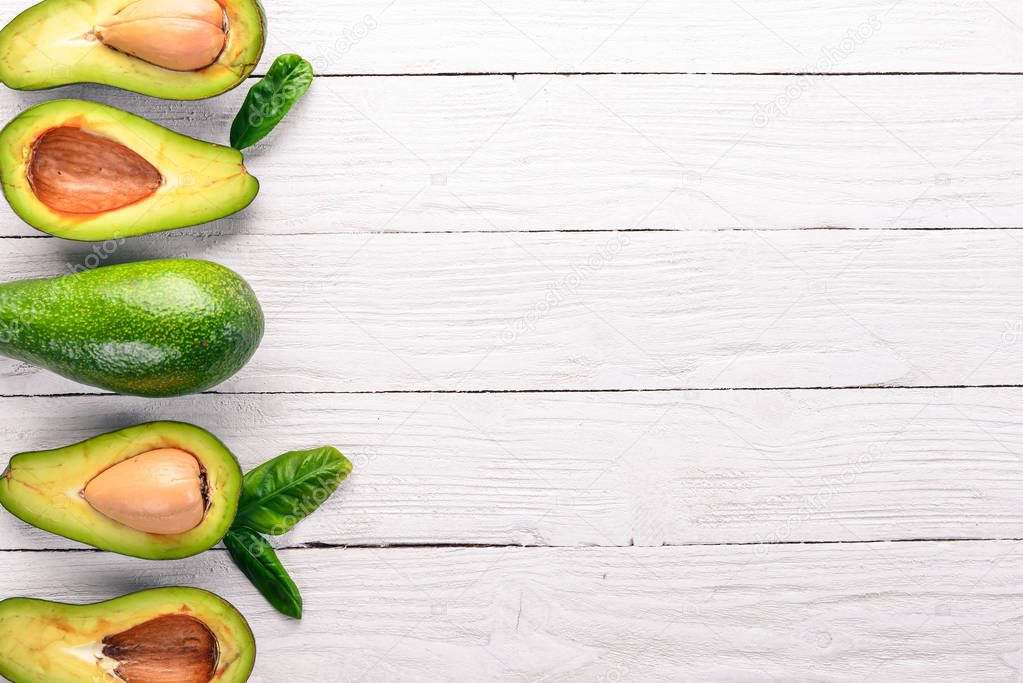 Avocado on a wooden background. Top view. Free space for your text.