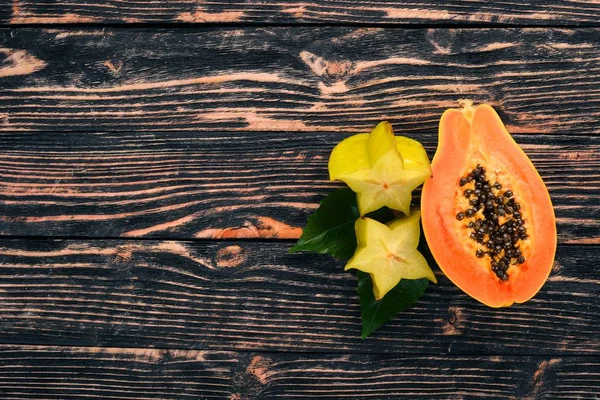 木瓜和杨桃 新鲜的热带水果 在木制背景上 顶部视图 复制空间 — 图库照片