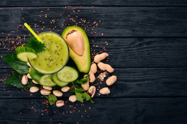 Avokado ve salatalık keten tohumu ve fındık ile güler yüzlü. Ahşap bir arka plan üzerinde. Üstten Görünüm. Metniniz için boş alan.